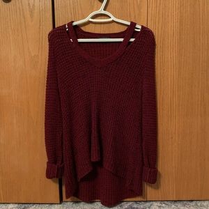 A burgundy V-neck sweater